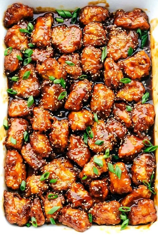 Baked Honey Sesame Chicken served with vegetables and rice, showcasing restaurant-style presentation