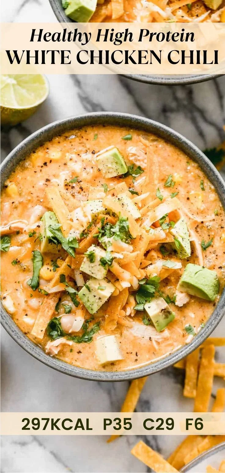 Bowl of high protein white chicken chili garnished with cilantro and lime