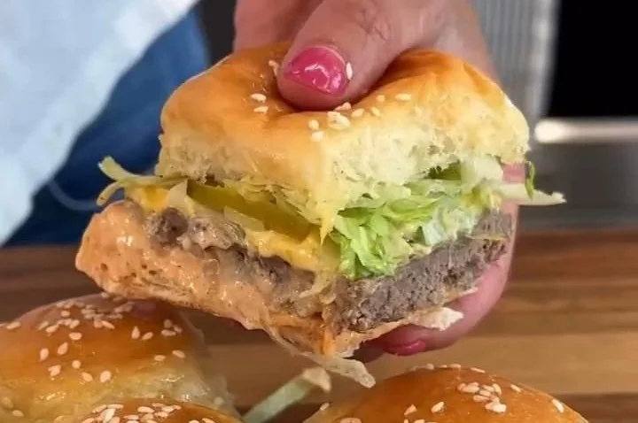 An appetizing plate of Big Mac sliders garnished with lettuce and cheese