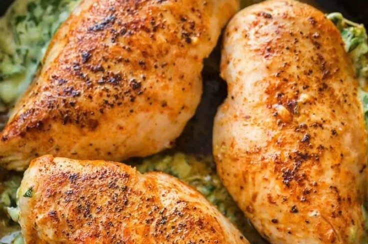 Cheesy spinach stuffed chicken breast garnished and ready to serve