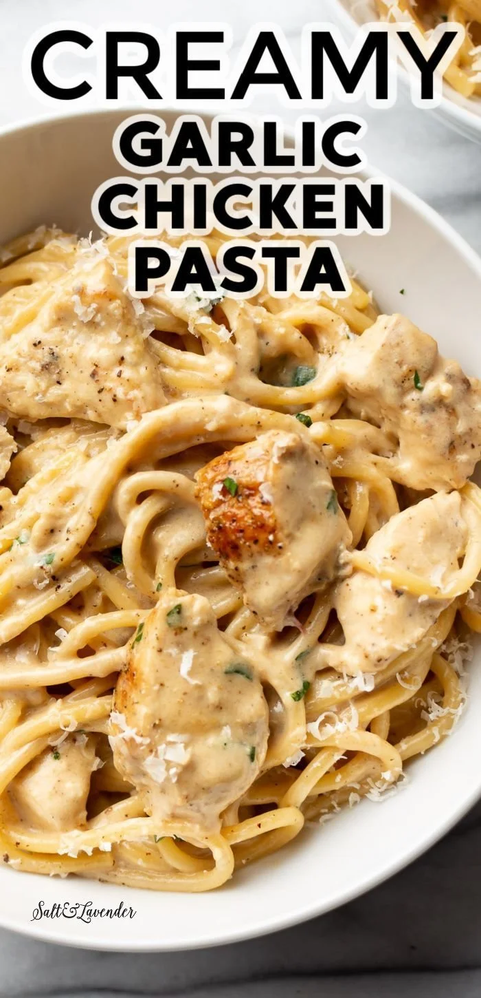 Creamy garlic chicken pasta dish served in a bowl with fresh parsley garnish.