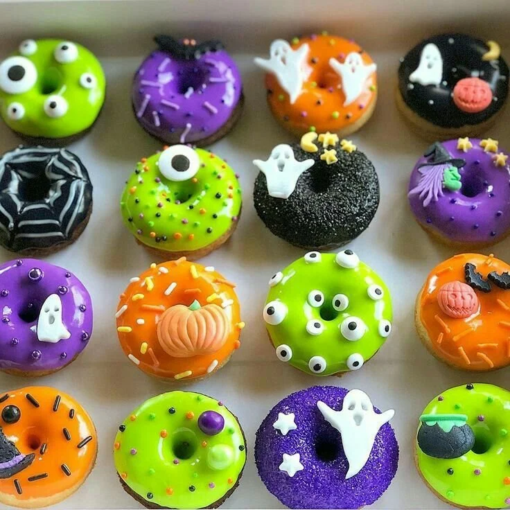 A variety of colorful and tasty donuts displayed on a platter
