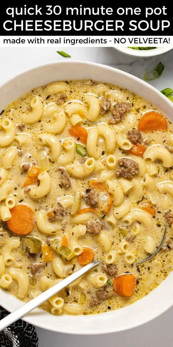 Bowl of hearty Easy Cheeseburger Soup topped with cheese and herbs
