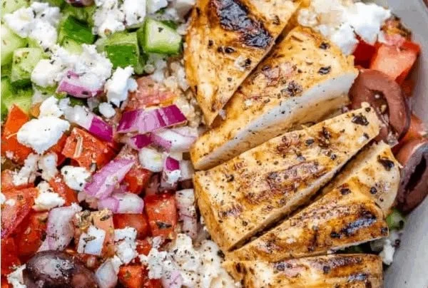 Greek Chicken Bowl featuring grilled chicken, fresh veggies, and tangy dressing