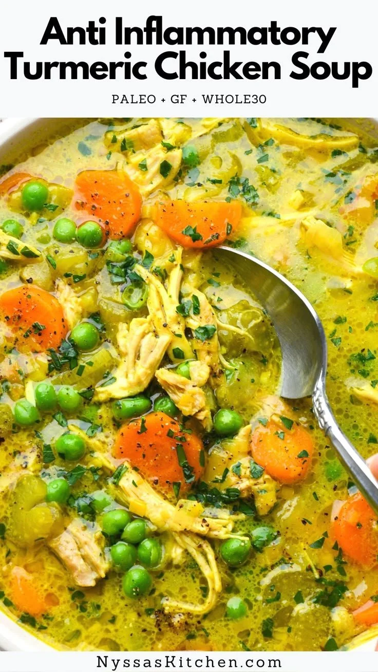 Bowl of healing turmeric chicken soup garnished with herbs and spices