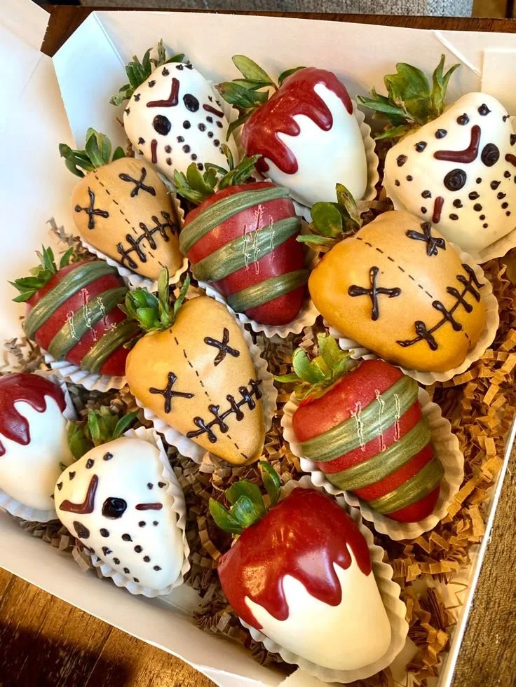 Horror themed chocolate covered strawberries with spooky decorations