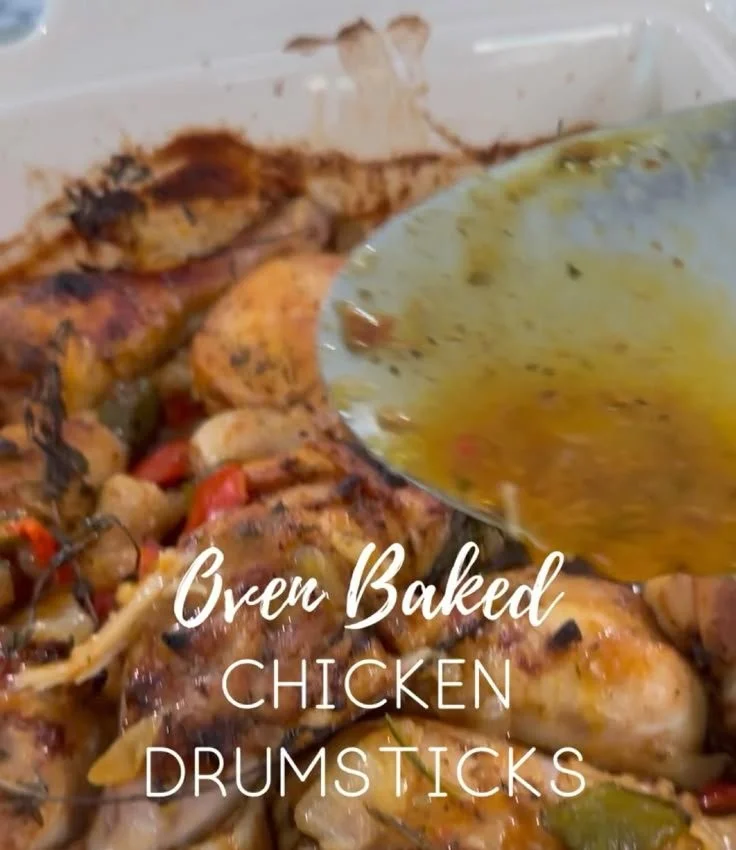 Oven baked chicken drumsticks served on a plate, garnished with herbs.