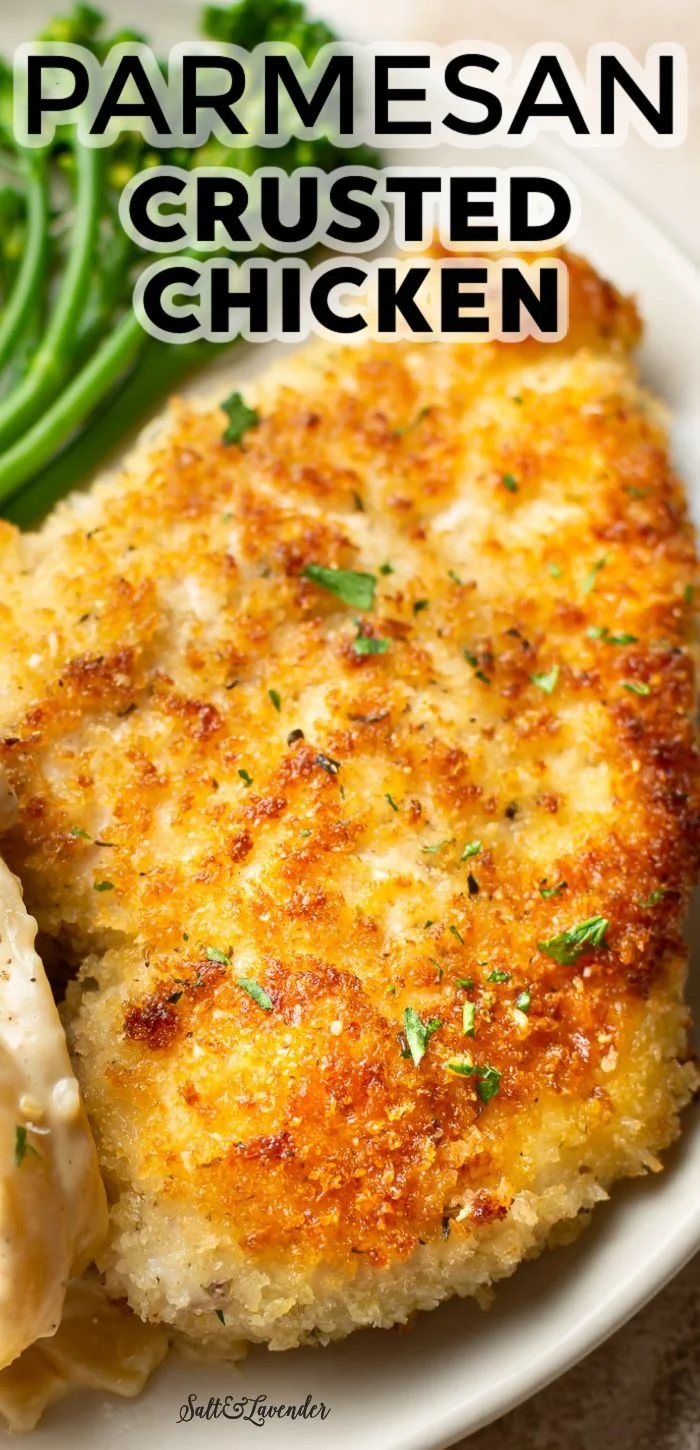Delicious Parmesan Crusted Chicken on a plate, garnished with herbs.