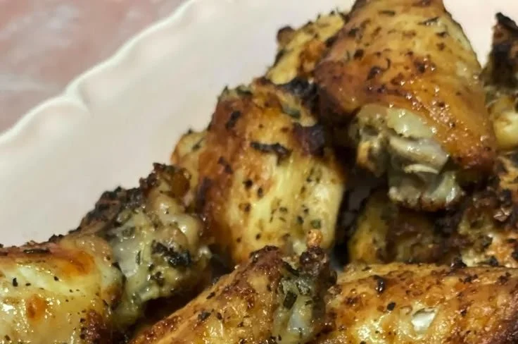 Plate of Rosemary Garlic Lemon Chicken garnished with herbs