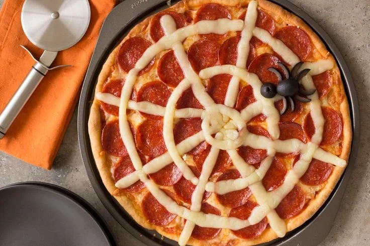 Spider Web Pepperoni Pizza creatively designed for Halloween by Rhodes Bake-N-Serv
