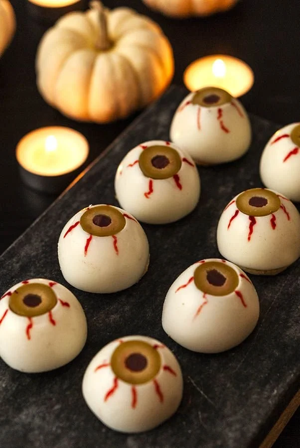 Spooky deviled eyeballs served on a platter for a Halloween party