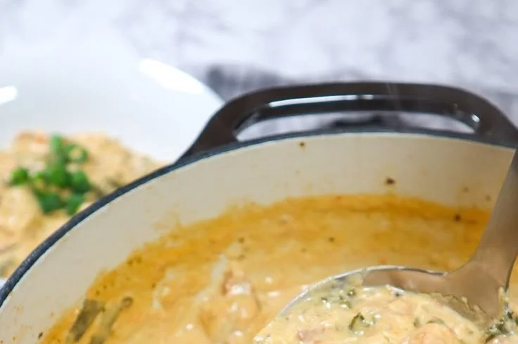 Bowl of creamy chicken gnocchi soup with fresh herbs and vegetables