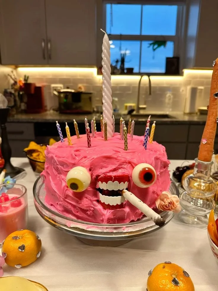 A unique and weird birthday cake featuring unusual decorations and flavors.